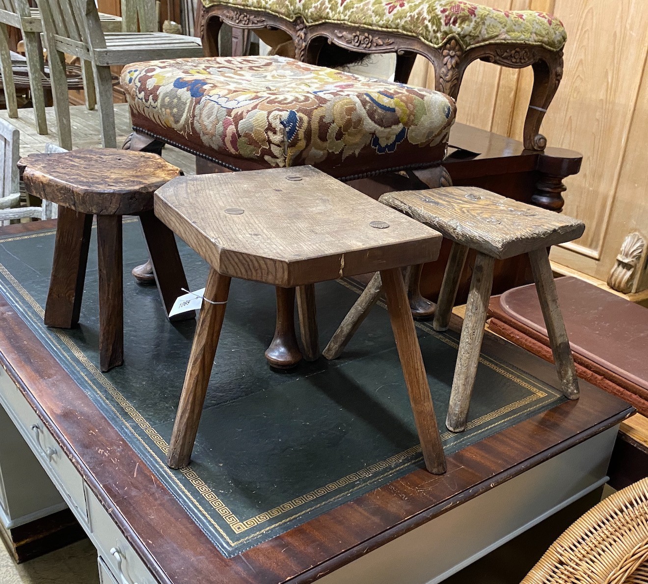 A George I style mahogany tapestry top dressing stool and three rustic stools